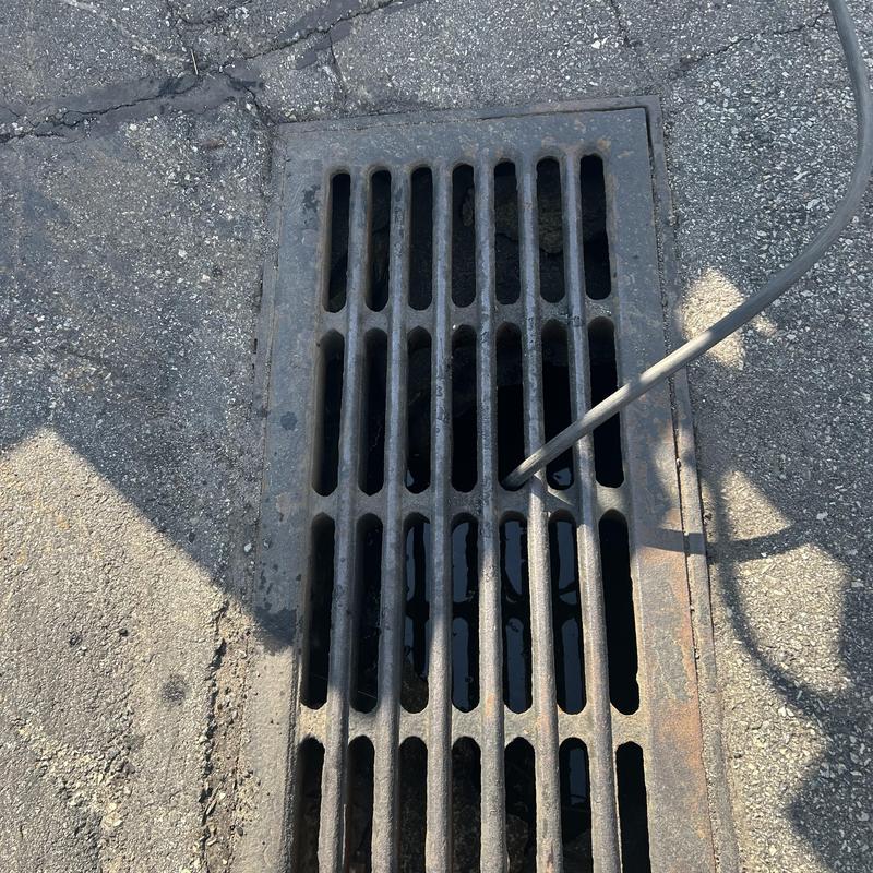 Storm drain jetting with water hose cleaning buildup Storm drain jetting with water hose cleaning buildup