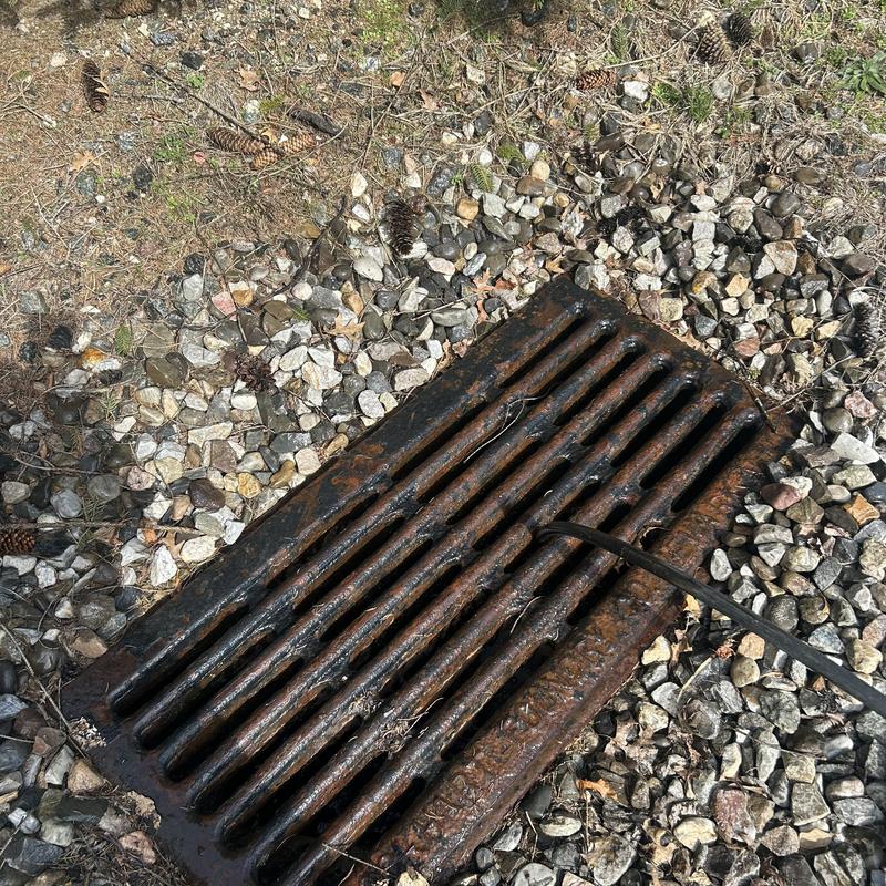 Drain grate with jetting hose for clog removal Drain grate with jetting hose for clog removal