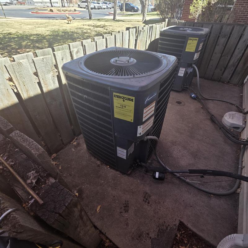 Air conditioning condenser unit with service cables outdoors