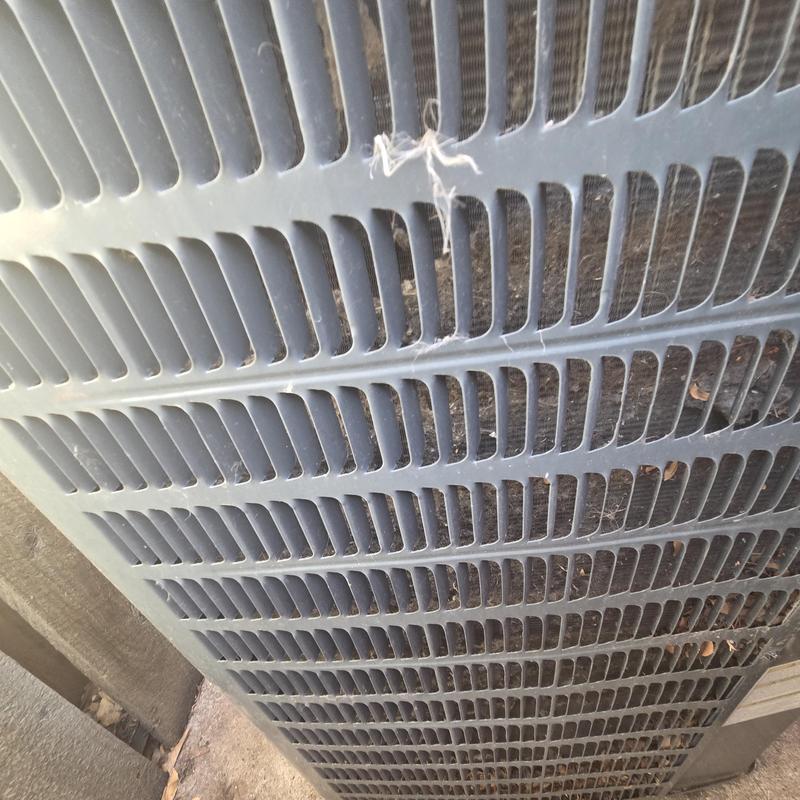 Outdoor air conditioner condenser unit grille with debris