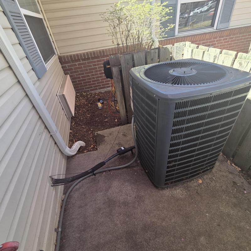 Central air conditioning unit with service lines outside house