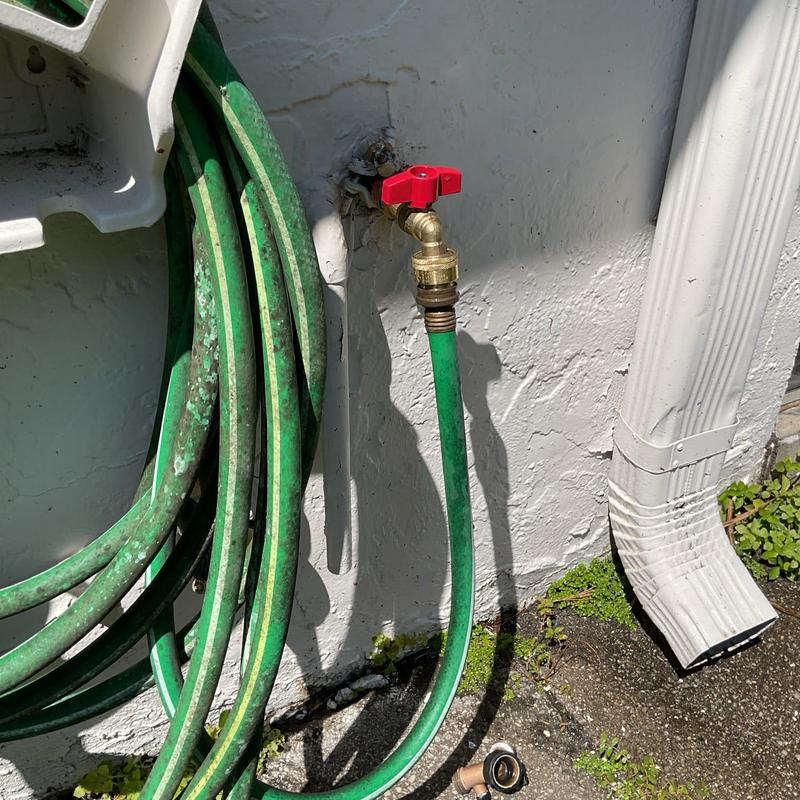 Quarter turn hose bib with garden hose attached