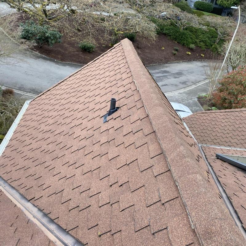 Pipe flashing and roof shingles installation on roof ridge