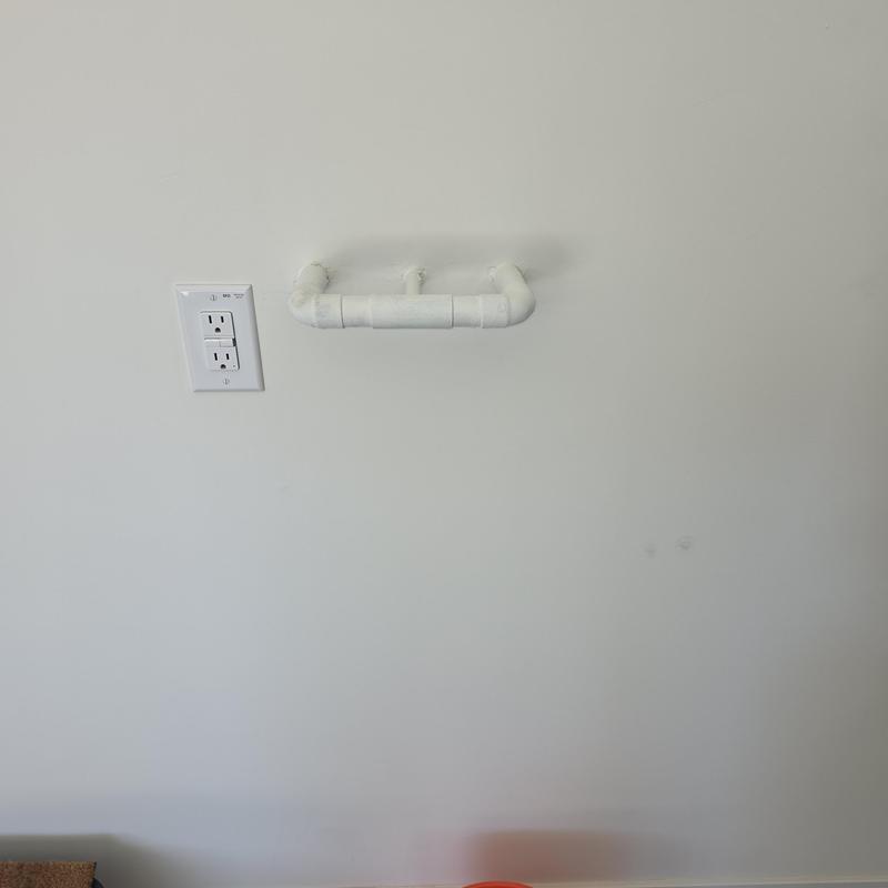 Water softener pipe installation on white wall