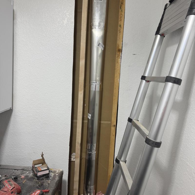 Dryer vent duct installation in wall cavity with ladder