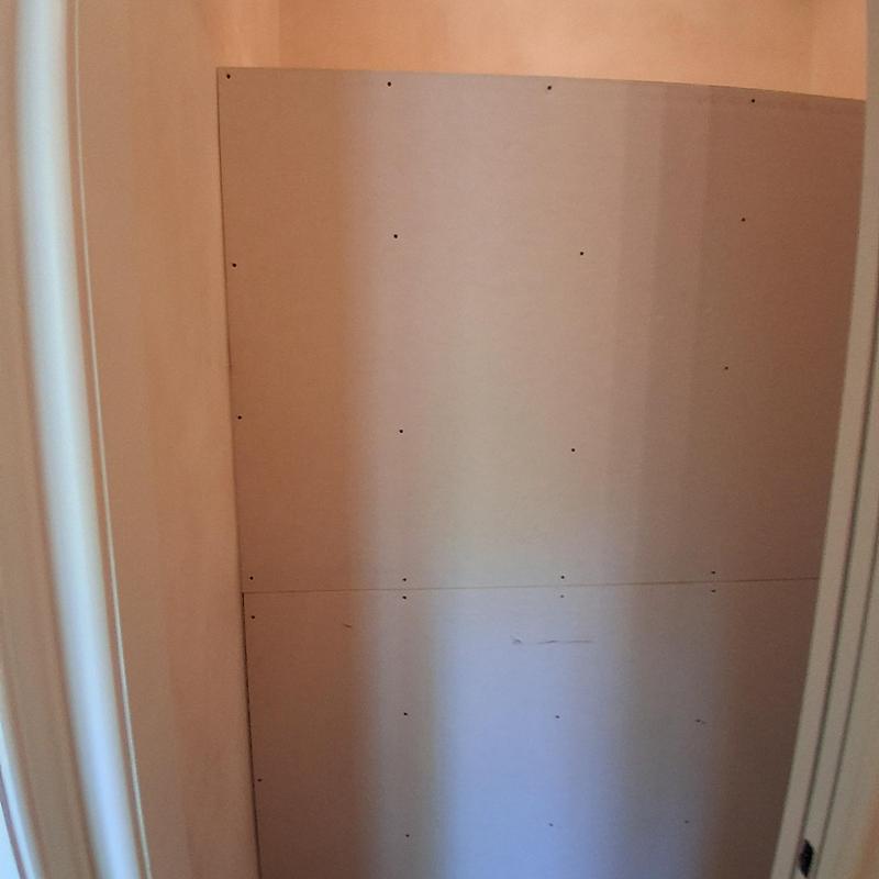 Closet wall drywall installation in progress