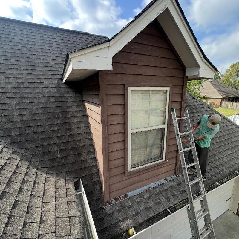 Cedar siding installation on dormer roof section
