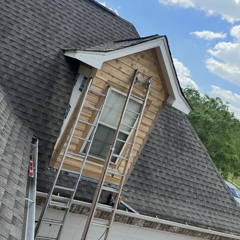 Cedar siding installation on dormer with ladders