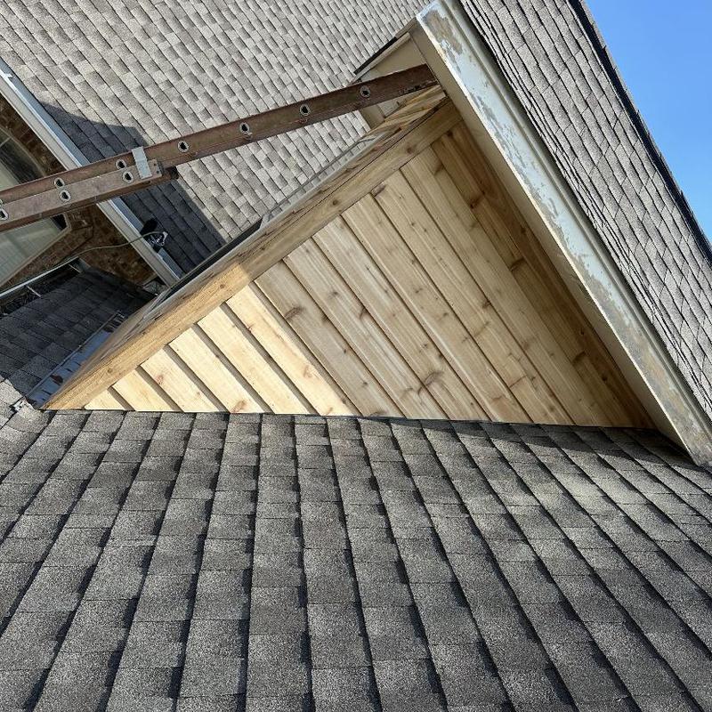 Cedar siding installation on dormer roof section