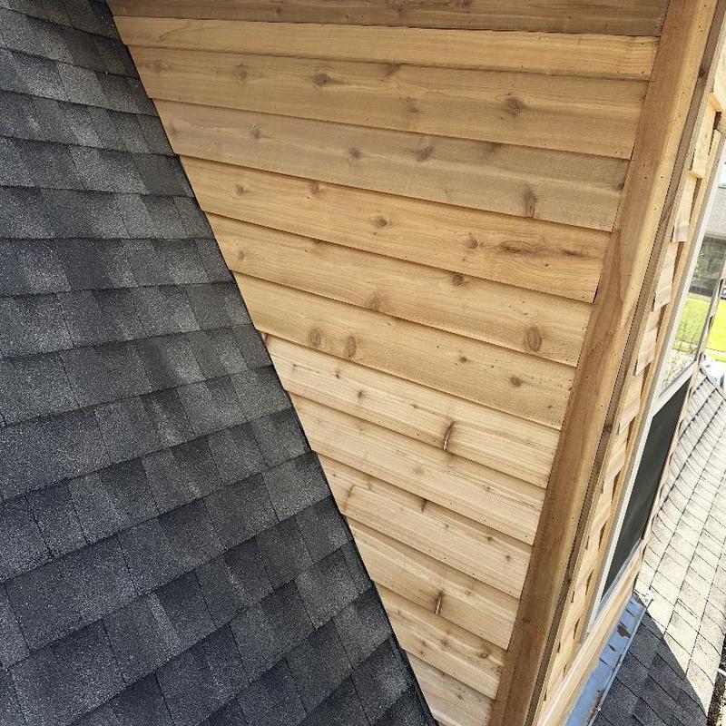 Cedar siding installation on roof dormer exterior