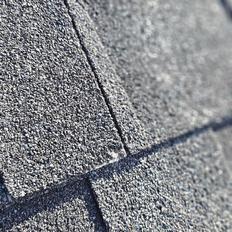 Asphalt shingles with hail damage close-up detail