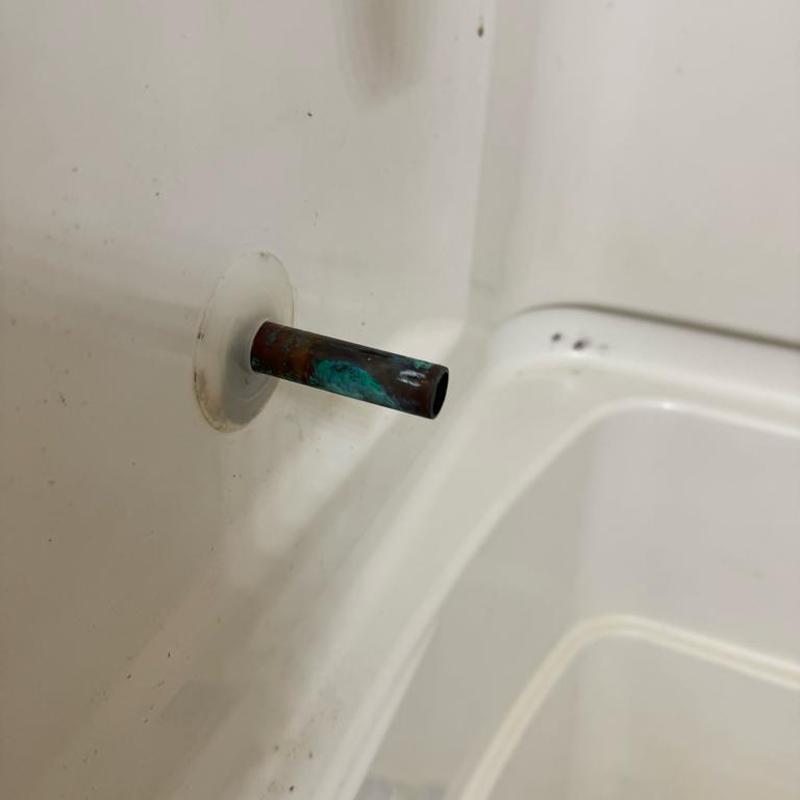 Slip-on tub spout pipe fitting in bathtub wall