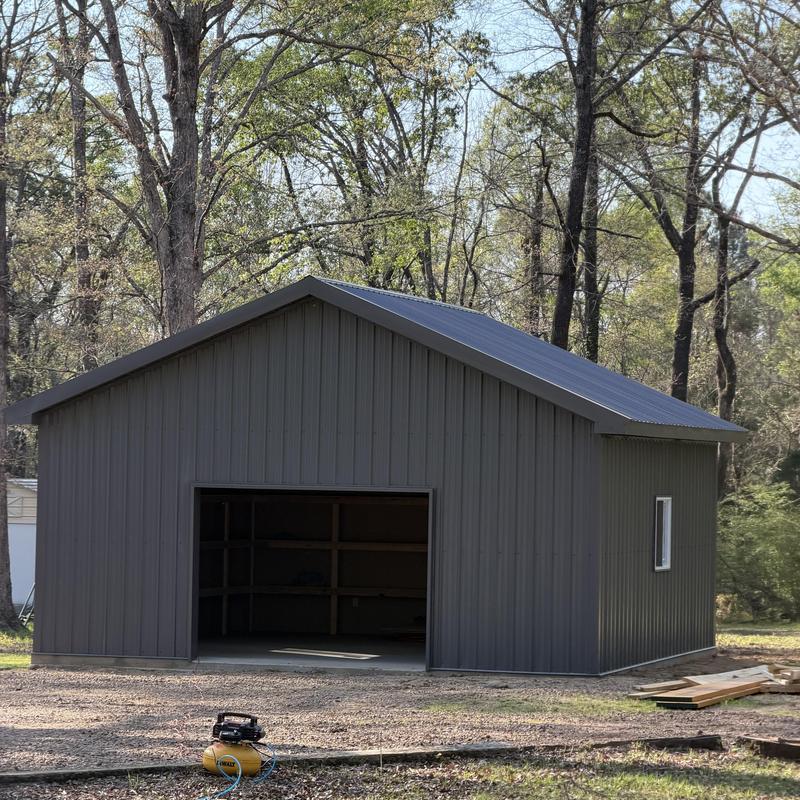 Metal garage building exterior with open door