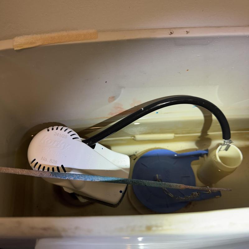 Toilet fill valve and flush assembly inside tank