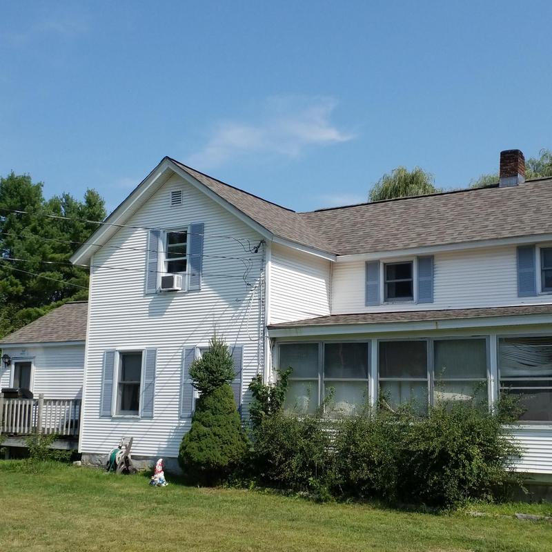 Architectural shingle roof replacement on white home