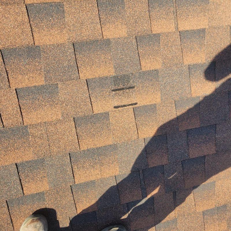 Asphalt roof shingles with granule loss and hip cap repairs