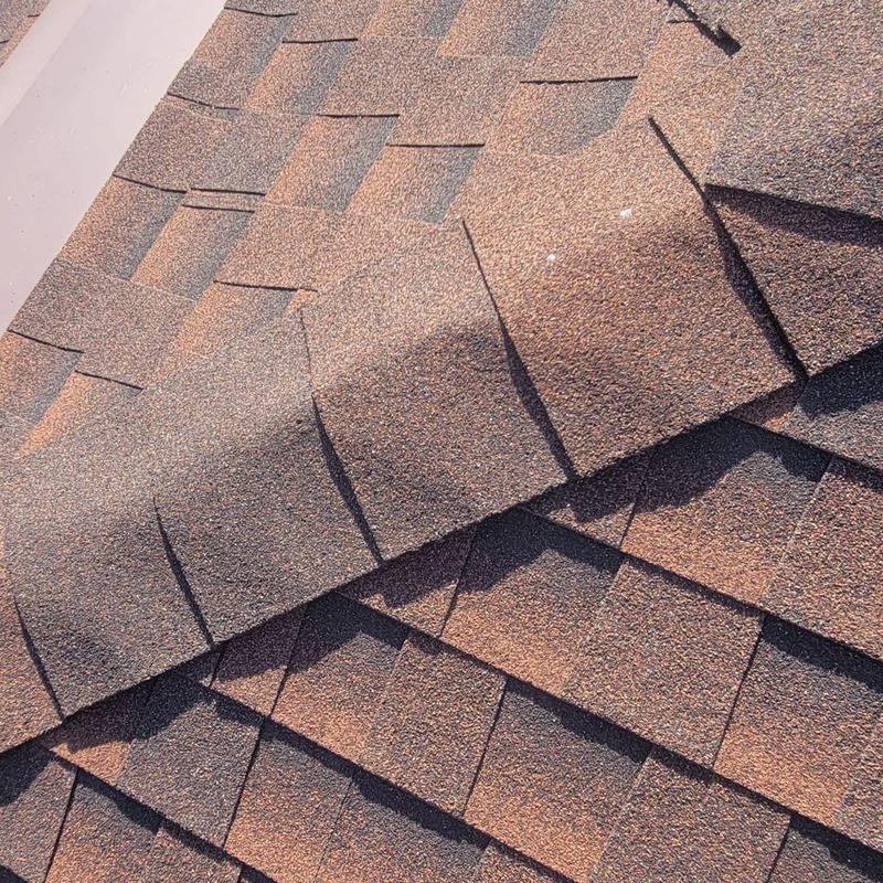 Hip cap shingles with granule loss on roof surface