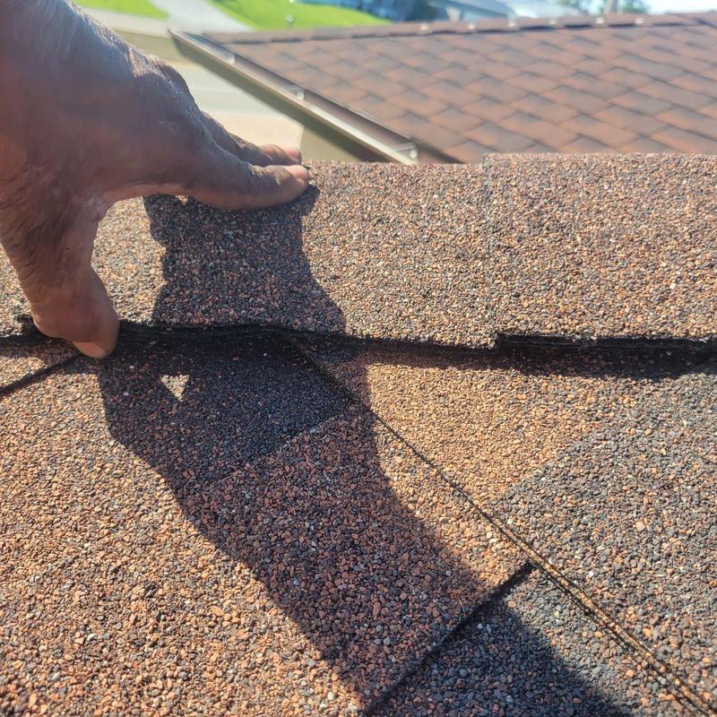 Hip cap shingles with granule loss on roof ridge