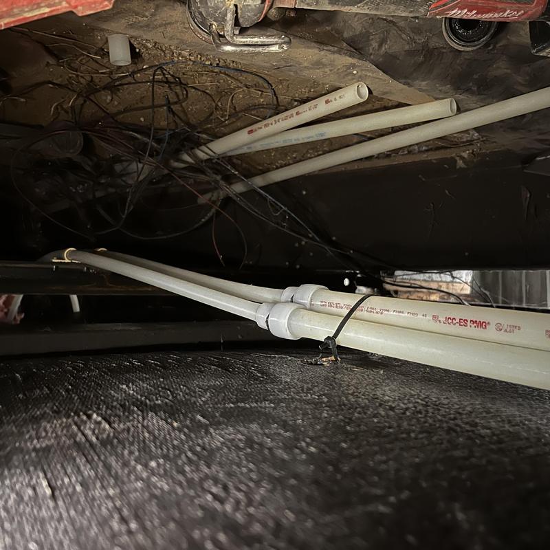 PEX piping and fittings installed under home floor PEX piping and fittings installed under home floor