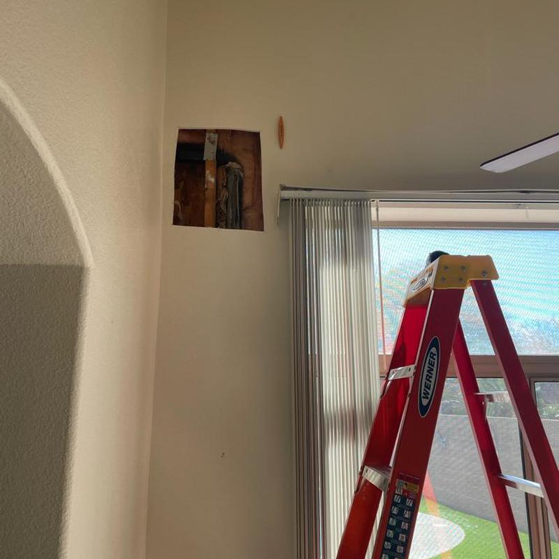 2 inch ABS drain pipe cutout in wall above ladder