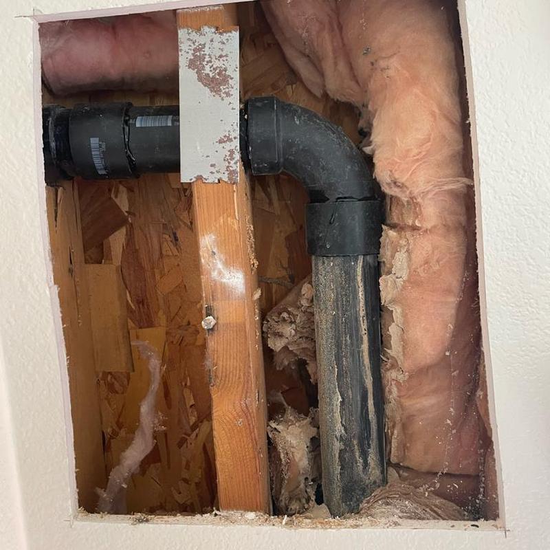 2 inch ABS drain pipe cut and reinstalled in wall cavity