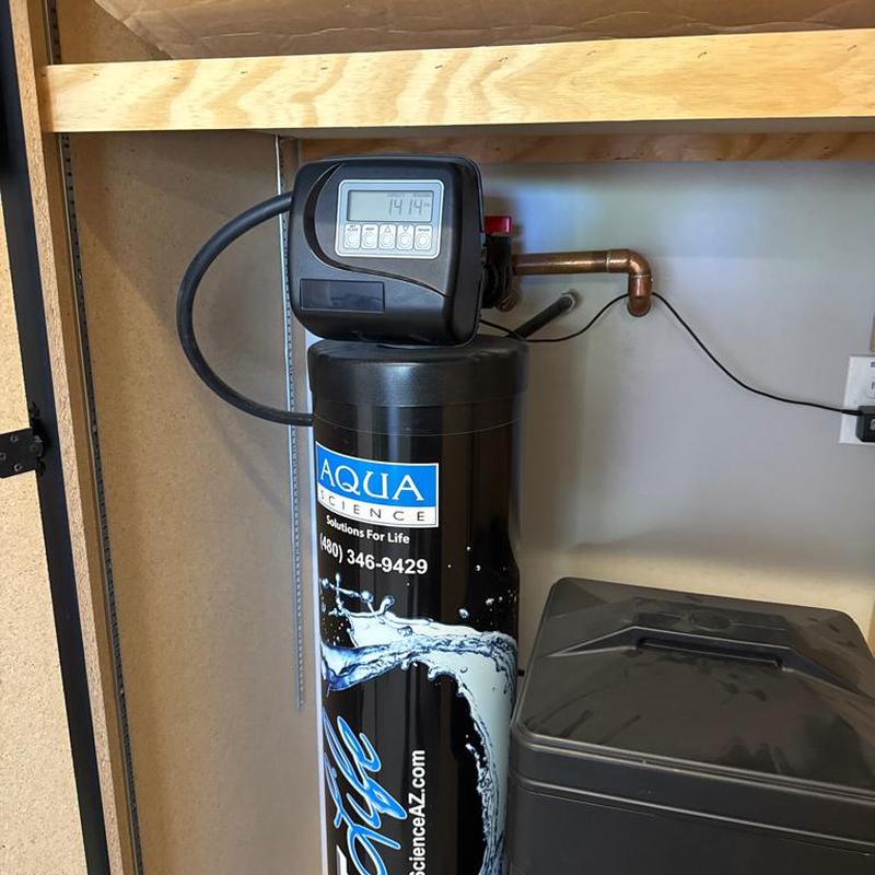 Water softener system with control valve in laundry room