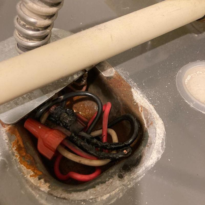 Electric water heater wiring with burnt insulation damage