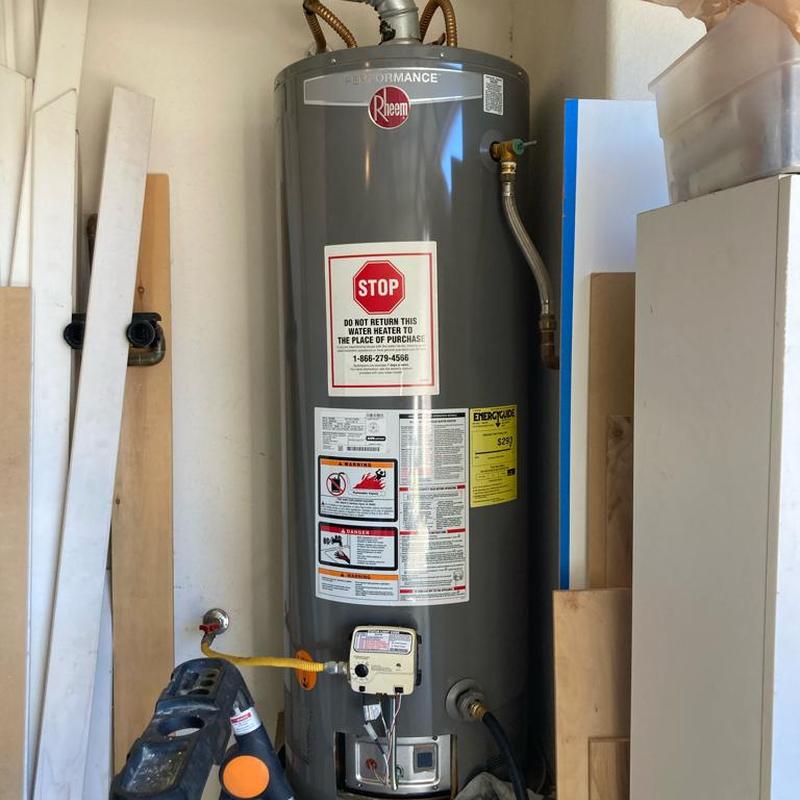 Rheem gas water heater with warning labels installed