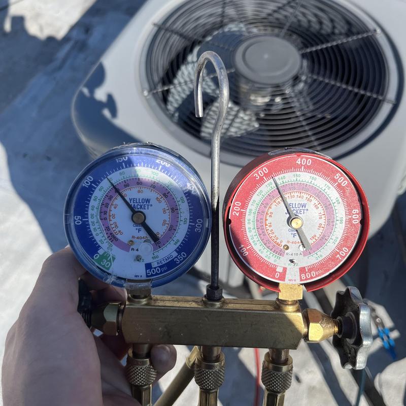 R-410A refrigerant gauges on rooftop AC unit