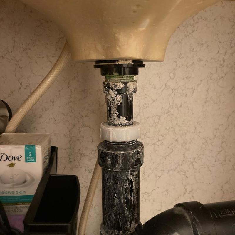 Bathroom sink drain pipe with corrosion buildup