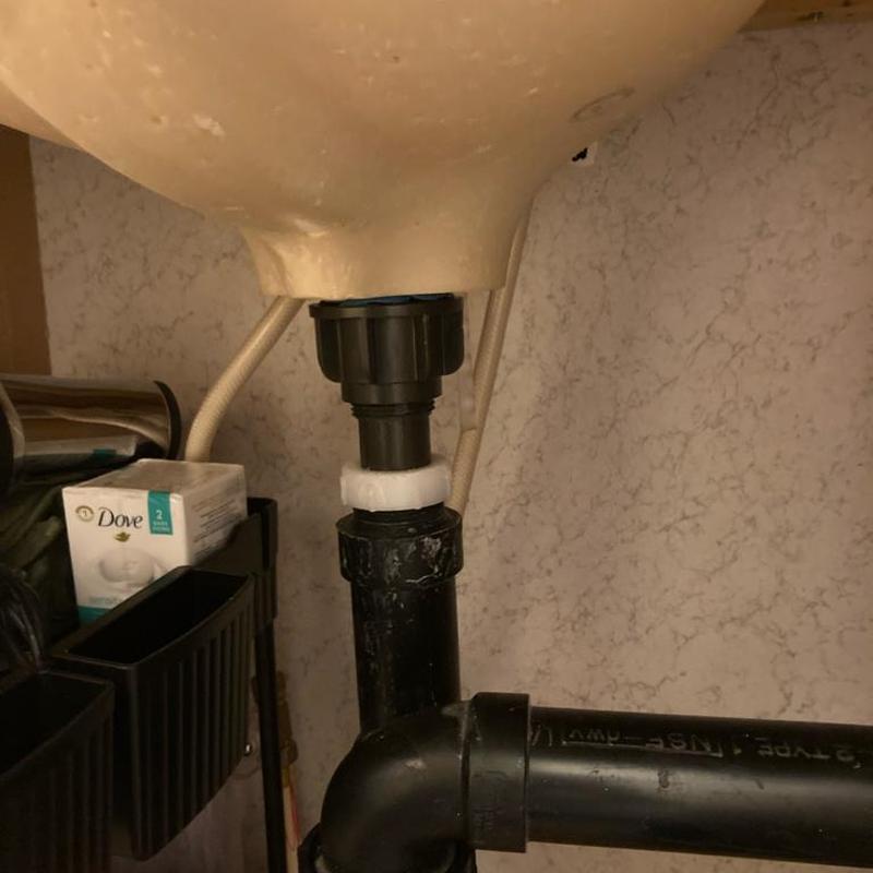 Bathroom sink Kohler drain and black PVC piping connection