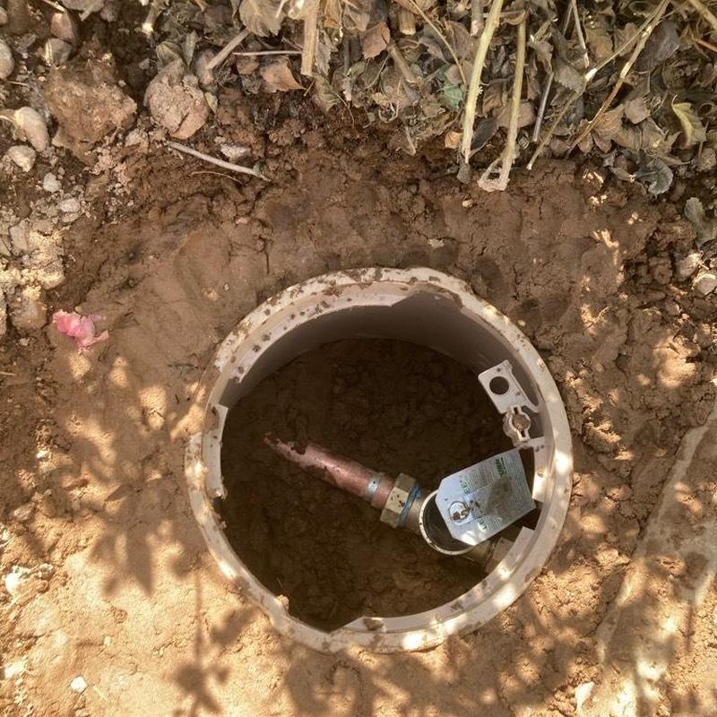 Main water line with pressure reducing valve access box in soil