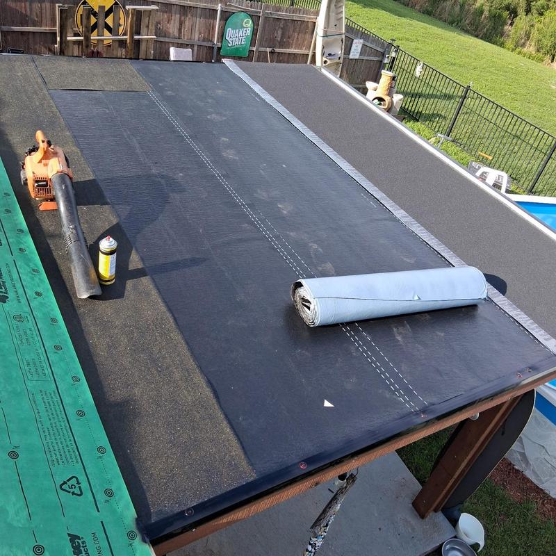 Flat roof membrane installation with tools on deck