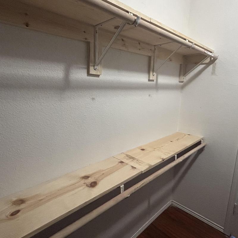 Custom wooden closet shelving and hanging rods installation
