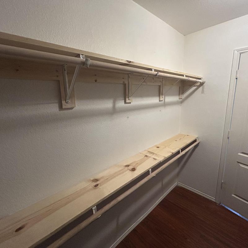 Custom wooden closet shelving with hanging rod installation