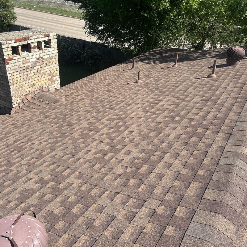 Asphalt shingle roof with vent pipes and chimney