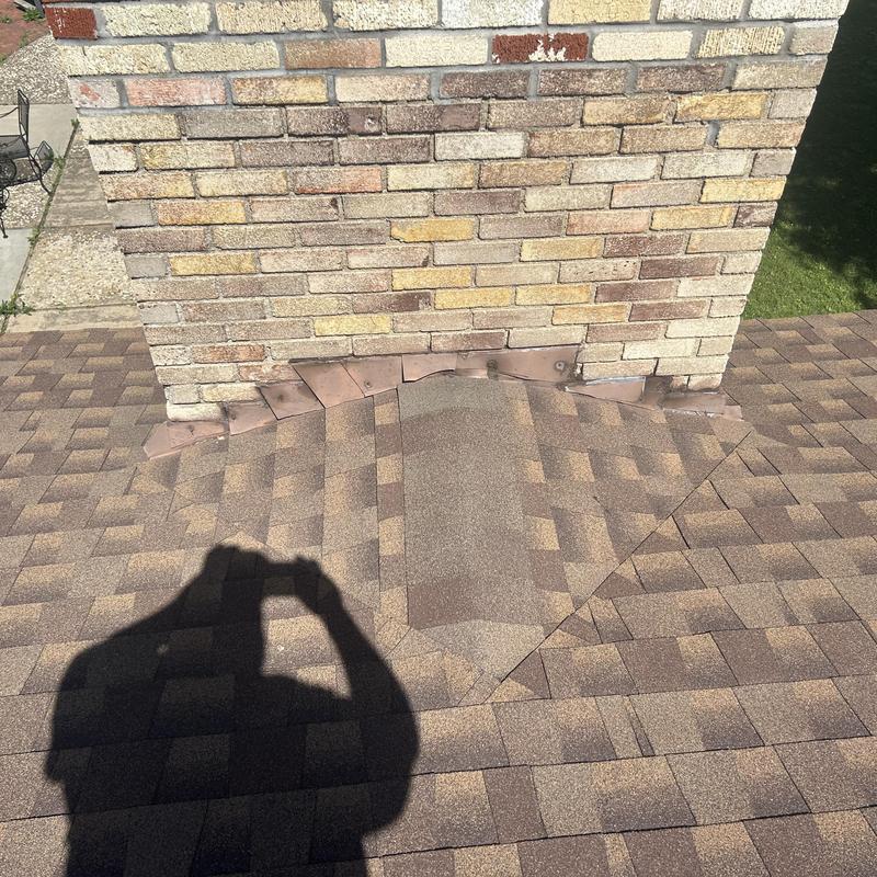 Roof shingles and chimney flashing on residential roof