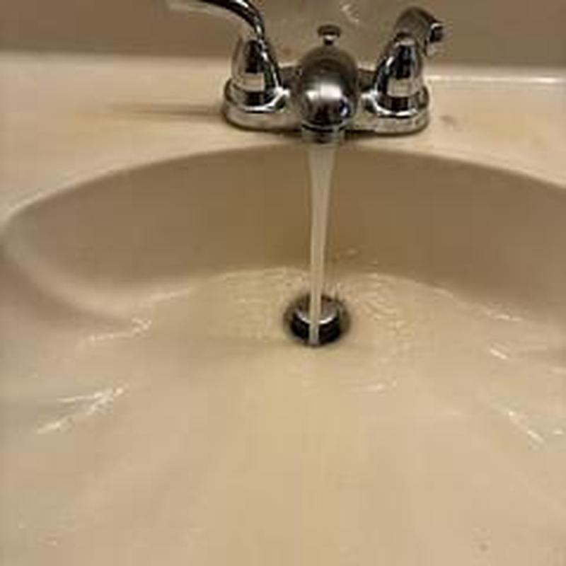 Lavatory faucet with water running into sink basin