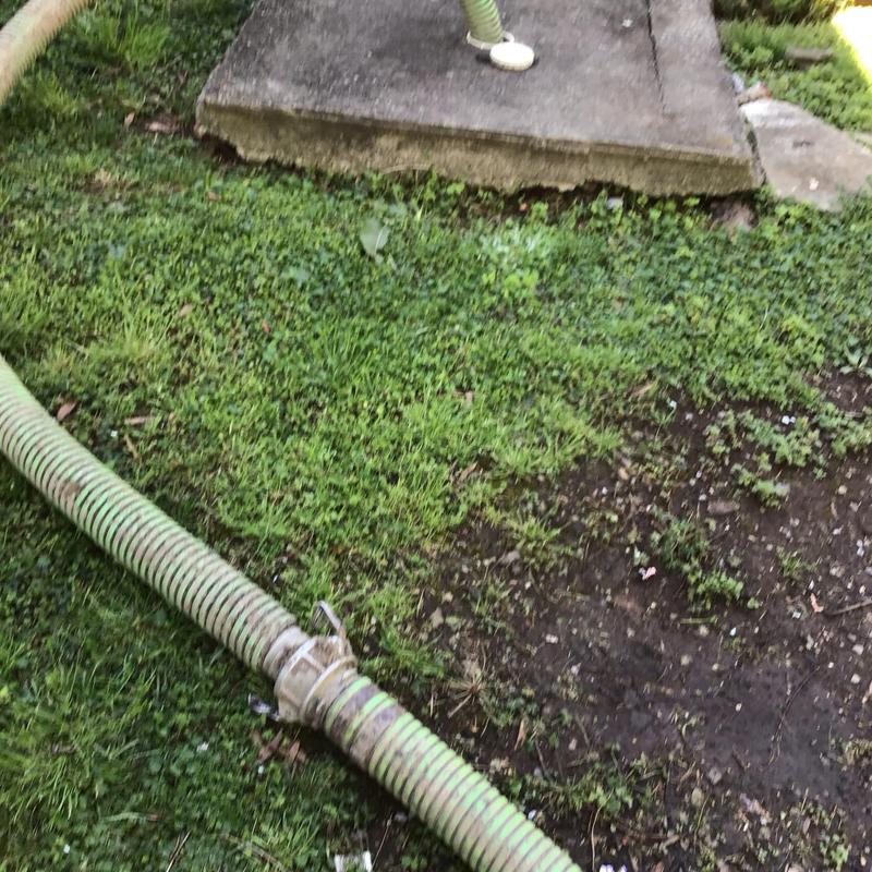 Septic tank pumping hose and access cover outdoors