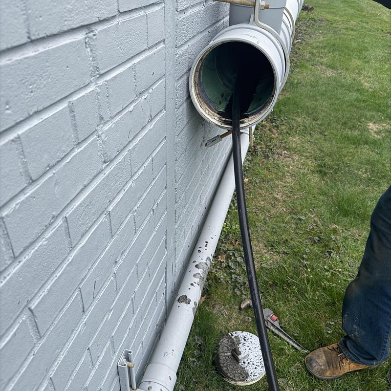 Outdoor drainage pipe cleaning with plumbing snake tool Outdoor drainage pipe cleaning with plumbing snake tool