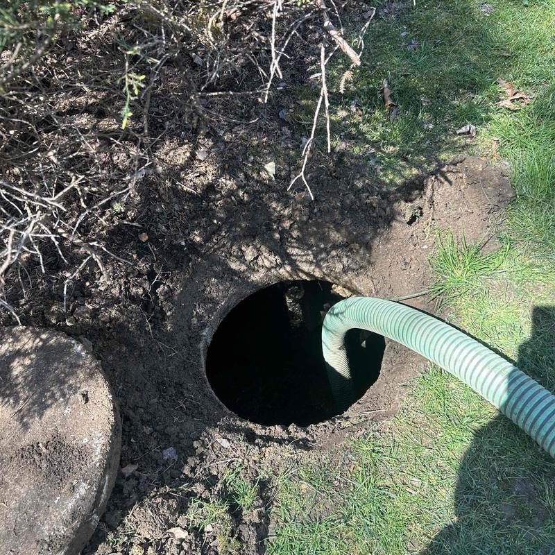 Septic tank with hose inserted for pumping service