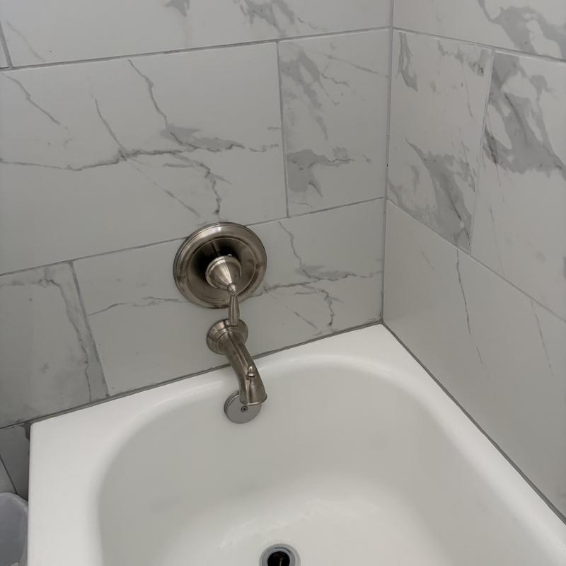 Bathtub faucet and valve installation with marble tile Bathtub faucet and valve installation with marble tile
