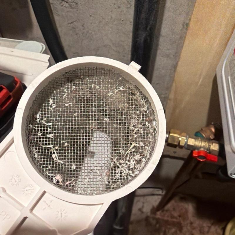 Heat exchanger screen with debris buildup inside housing
