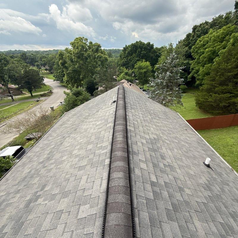 Asphalt shingle roof with ridge cap vent and aging wear