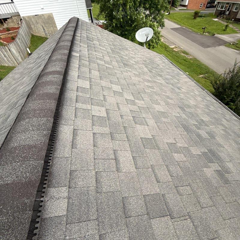 Asphalt shingle roof with ridge vent in residential area