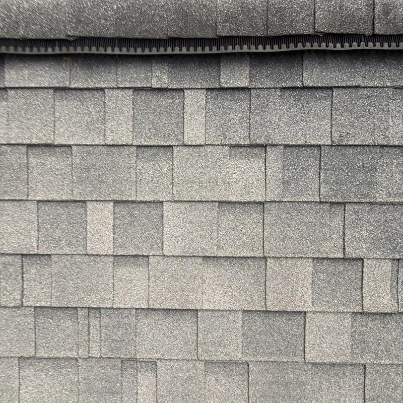 Asphalt shingles with hail damage on roof surface