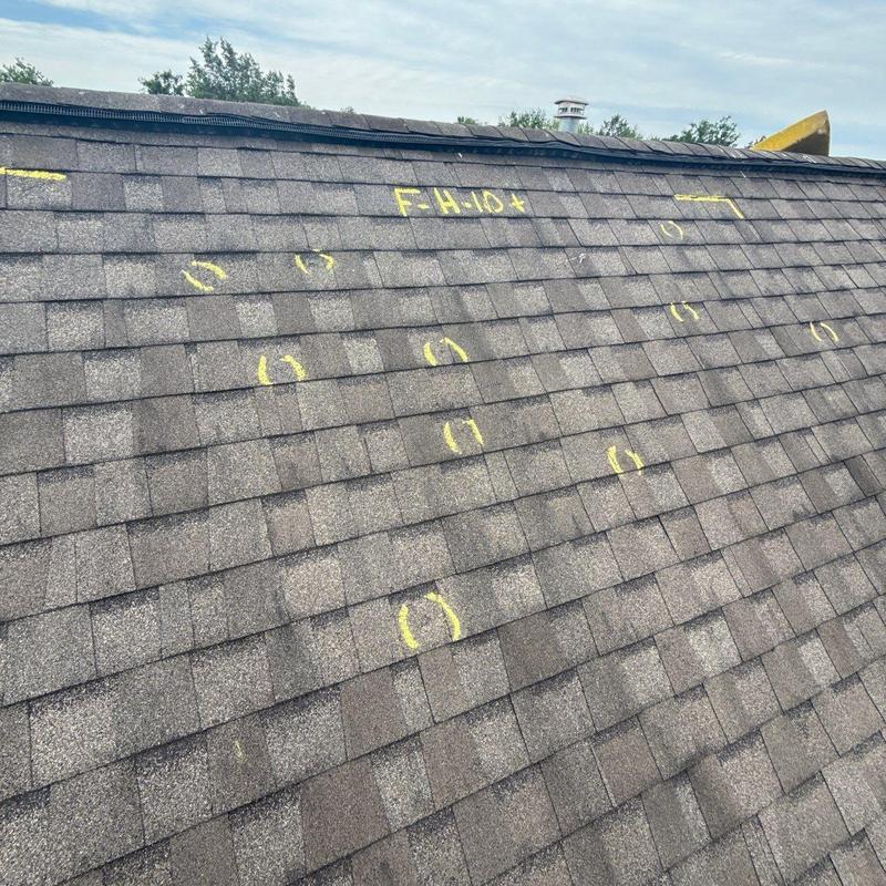 Asphalt roof shingles with hail damage markings