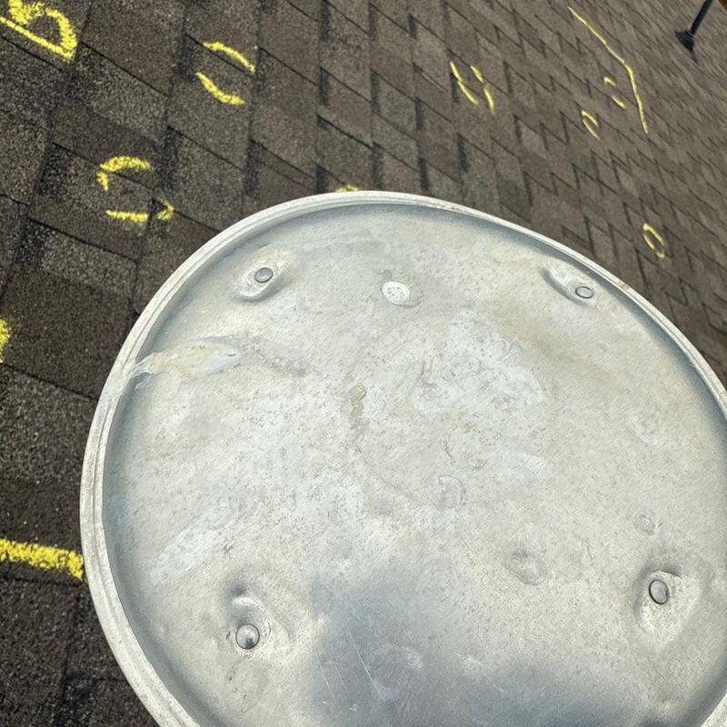 Roof shingles with hail damage marked in yellow