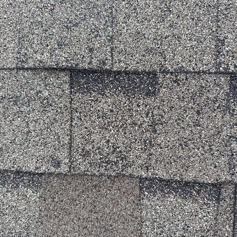 Roof shingles with hail damage and wind lifting