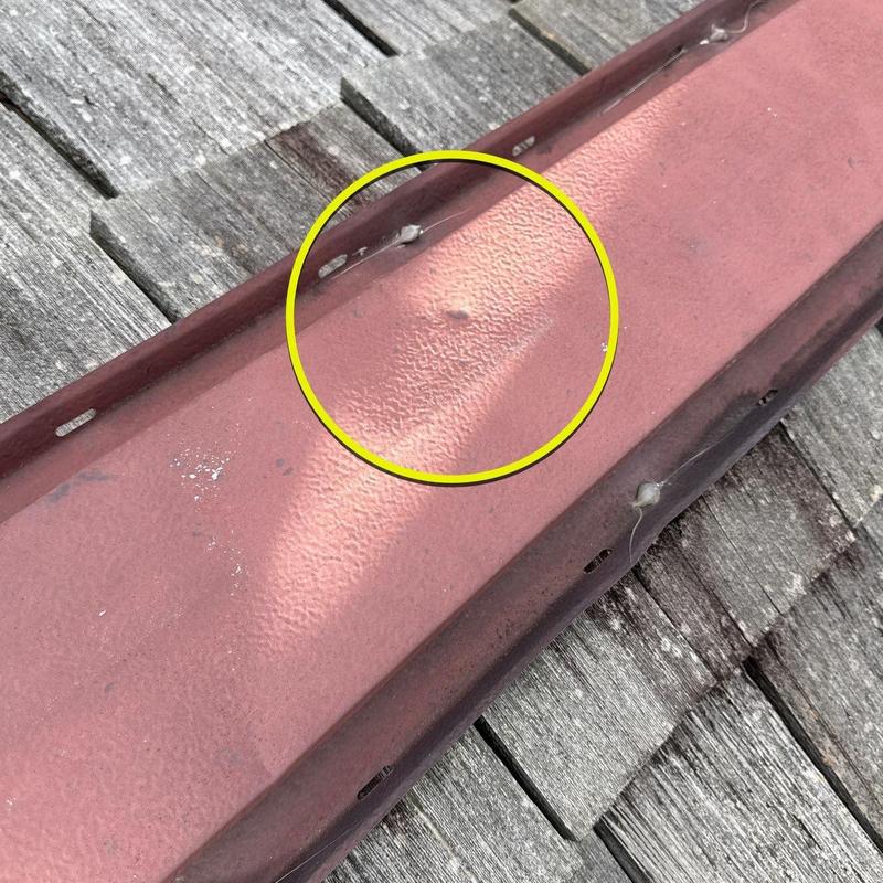 Metal roof flashing with hail dent damage inspection